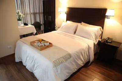 a hotel room with a large bed with a tray on it at Park Hotel Lima in Lima