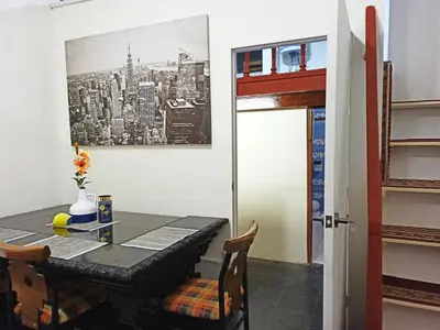 a dining room with a table and chairs at Royalty Inn in Lima
