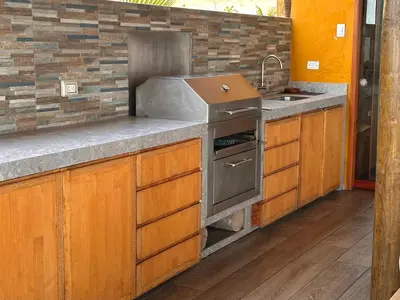 a kitchen with a stove and a sink at Refugio del Mar Wakama in San Vicente de Cañete