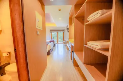 a room with shelves and a bedroom with a bed at Hotel Andesmar Huancayo in Huancayo