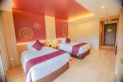 a hotel room with two beds and a colorful wall at Hotel Andesmar Huancayo in Huancayo