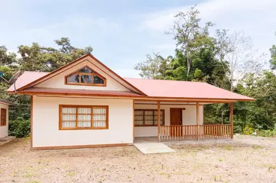 a small house with a red roof at Cabañitas San José in Oxapampa