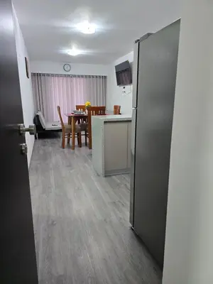 an open door to a kitchen and dining room at SAM Apartment Cusco in Cusco