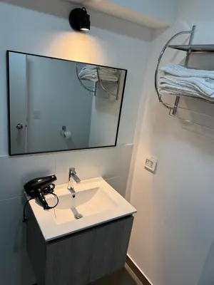 a bathroom with a sink and a mirror at SAM Apartment Cusco in Cusco
