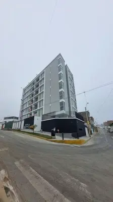 a large white building on the side of a street at Departamento en playa Arica in Lurín