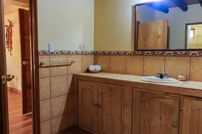 a bathroom with a sink and a mirror at Spacious entire house with awesome mountain views in Urubamba