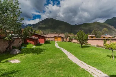 a field of grass with mountains in the background at Spacious entire house with awesome mountain views in Urubamba