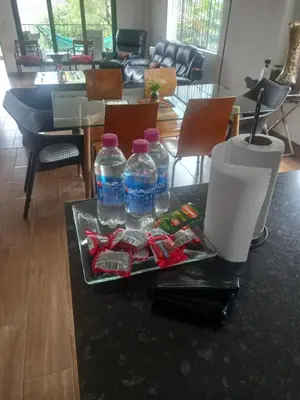 a table with two bottles of water and candy on it at CASA DE CAMPO CON PISCINA EN COCACHACRA HUAROCHIRI SOL TODO EL AÑo in Cocachacra