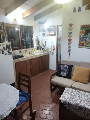 a living room with a couch and a kitchen at bungalows in Santa Rosa