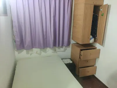 a bedroom with a bed and a purple window at bungalows in Santa Rosa