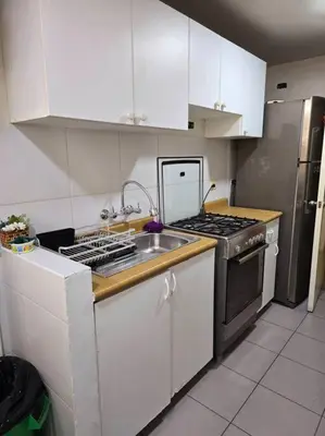 a kitchen with a sink and a stove top oven at El Refugio de Katte VI in Lima