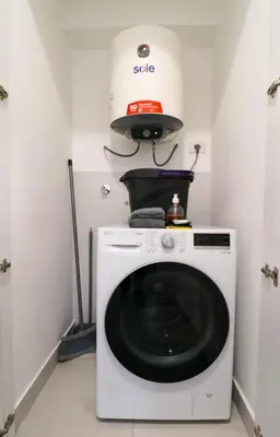a washing machine in a room with a stove at Qoyllur by Wynwood House in Cusco