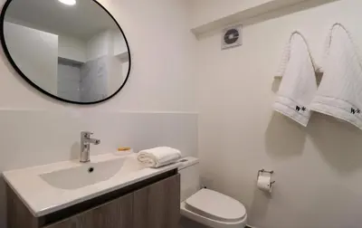 a white bathroom with a sink and a mirror at Qoyllur by Wynwood House in Cusco