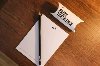 a book sitting on top of a wooden table with a sign at Vital by Wynwood House in Lima