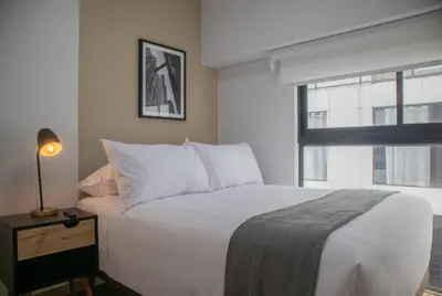 a bedroom with a white bed and a window at Vital by Wynwood House in Lima