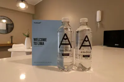 two bottles of water on a table with a welcome touador sign at Vital by Wynwood House in Lima