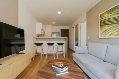 a living room with a couch and a table at Aquilaria by Wynwood House in Lima