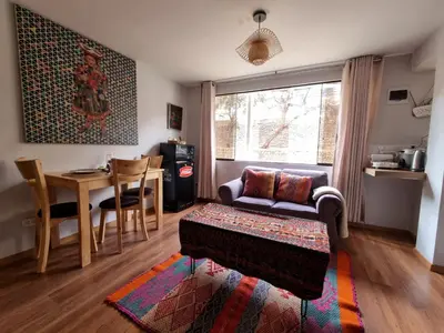 a living room with a couch and a table at boutique guest house art in the center of cusco in Cusco