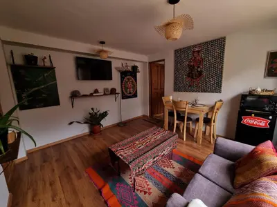 a living room with a couch and a table at boutique guest house art in the center of cusco in Cusco