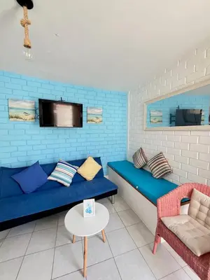 a living room with a blue couch and a table at 