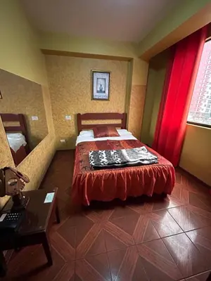 a bedroom with a bed with a redspread on it at Aquarium in Lima