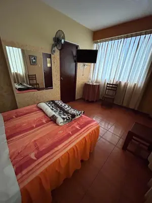 a hotel room with a bed and a mirror at Aquarium in Lima