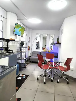 a kitchen and living room with a table and chairs at Departamento en el Centro Historico de Lima Perú in Lima
