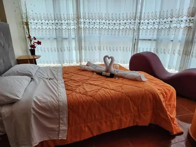 a bedroom with a bed with two towels on it at Yanachaga Hotel - Oxapampa in Oxapampa