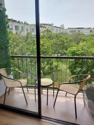 three chairs and a table on a balcony with a view at Lovely & quiet place, park view & private parking in Lima