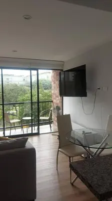 a living room with a couch and a glass table at Lovely & quiet place, park view & private parking in Lima