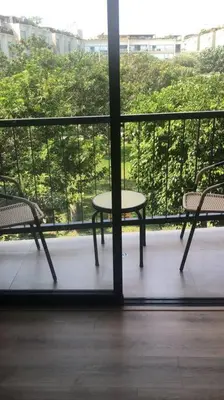 a balcony with a table and two chairs on a balcony at Lovely & quiet place, park view & private parking in Lima