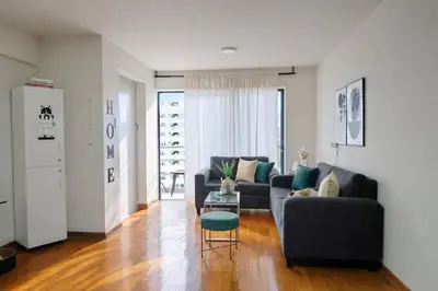 a living room with two couches and a table at Habitación Baño Compartido en Departamento Compartido in Lima