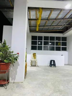 a room with a table and a chair and windows at Casa de Campo y Hospedaje Irma in Lunahuaná