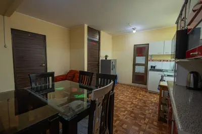 a kitchen with a table and chairs in a room at Depawanka 3 Departamento amoblado y equipada in Huancayo
