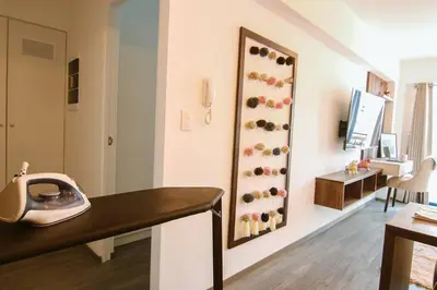 a room with a desk with a phone on a wall at Moderno Loft a Pasos del Centro in Cusco