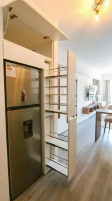 a kitchen with a refrigerator and a dining room at Moderno Loft a Pasos del Centro in Cusco