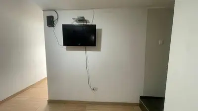 a flat screen tv on a wall in a room at Acogedor departamento en Los Olivos 3 dormitorios in Lima