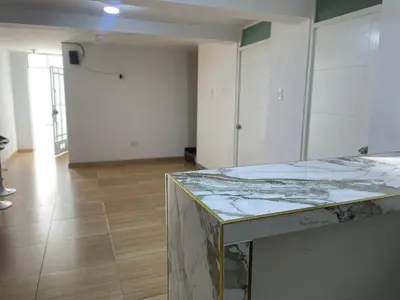 an empty room with a marble counter top in the middle of a room at Acogedor departamento en Los Olivos 3 dormitorios in Lima