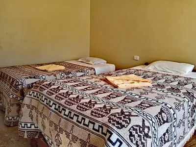 two beds sitting next to each other in a room at INCA COFFEE Lodge Lucmabamba in Sahuayacu