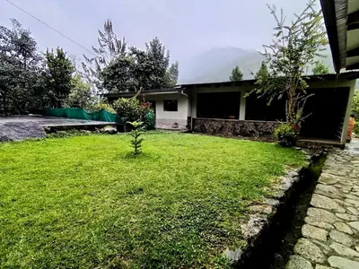 a house with a green lawn in front of it at INCA COFFEE Lodge Lucmabamba in Sahuayacu