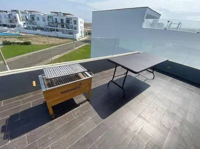 a table on the balcony of a building at Casa de Playa muy cerca al mar, piscina exclusiva! in Islote Los Leones