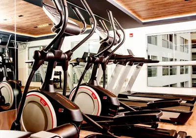 a row of exercise bikes in a gym at G15 Apartments by Vibrant in Lima