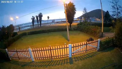 a park with a fence and a palm tree at bungalows in Santa Rosa