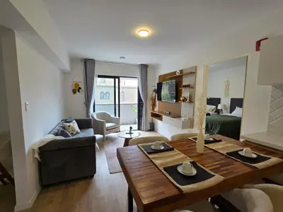 a living room with a table and a couch at Apartamento full equipado en barranco in Lima