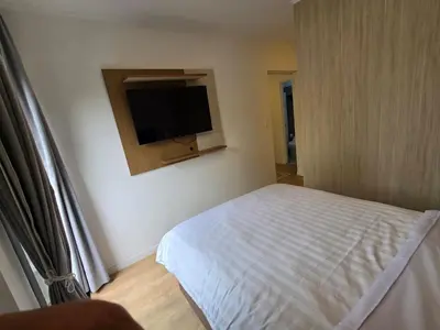 a bedroom with a bed and a flat screen tv at Apartamento full equipado en barranco in Lima