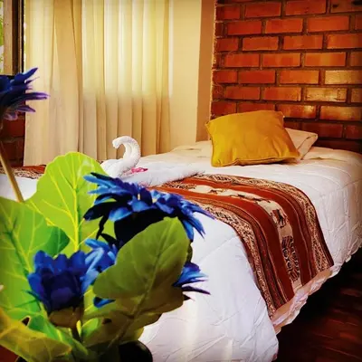 a bedroom with a bed with a bird on it at Amira's House Cusco in Cusco