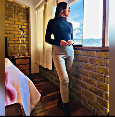 a woman standing in a room looking out a window at Amira's House Cusco in Cusco