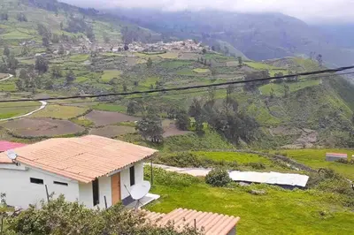 a house on a hill with a view of a mountain at Casa de campo con impresionante vista a las montañas y cascada en Canta in Canta