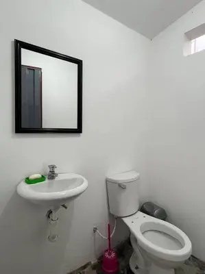 a bathroom with a toilet and a sink and a mirror at Casa de campo con impresionante vista a las montañas y cascada en Canta in Canta