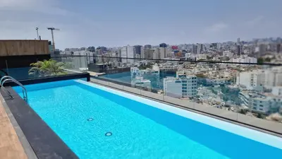 a swimming pool on the roof of a building at Apartamento en Miraflores in Lima